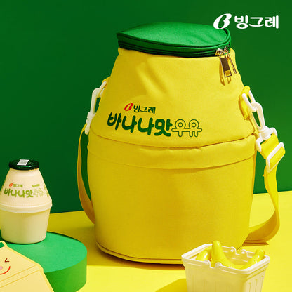 Binggrae Banana Milk bottle-shaped yellow and green insulated cooler bag with adjustable shoulder strap on yellow and green background