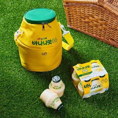 Binggrae Banana Milk insulated cooler bag in yellow with green top on picnic grass, shown with Binggrae Banana Milk bottles and picnic basket