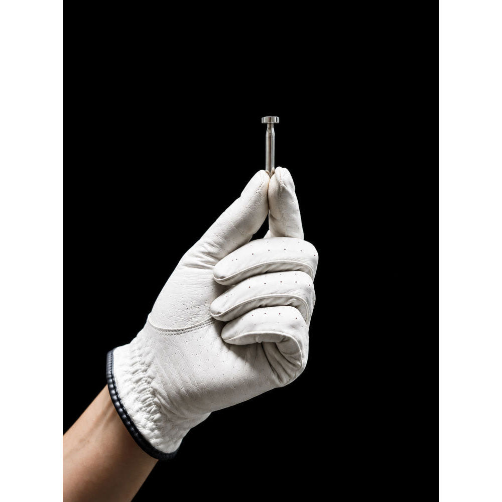 Gloved hand holding OPT Golf Balance Pin Swing Trainer weight