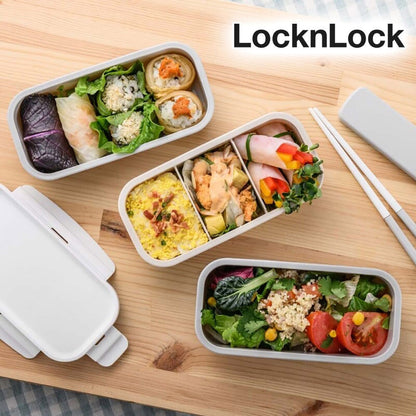 Filled LocknLock bento lunchboxes with assorted foods on a wooden table
