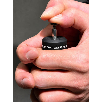 Hand inserting OPT Golf Balance Pin Swing Trainer weight into OPT Golf product
