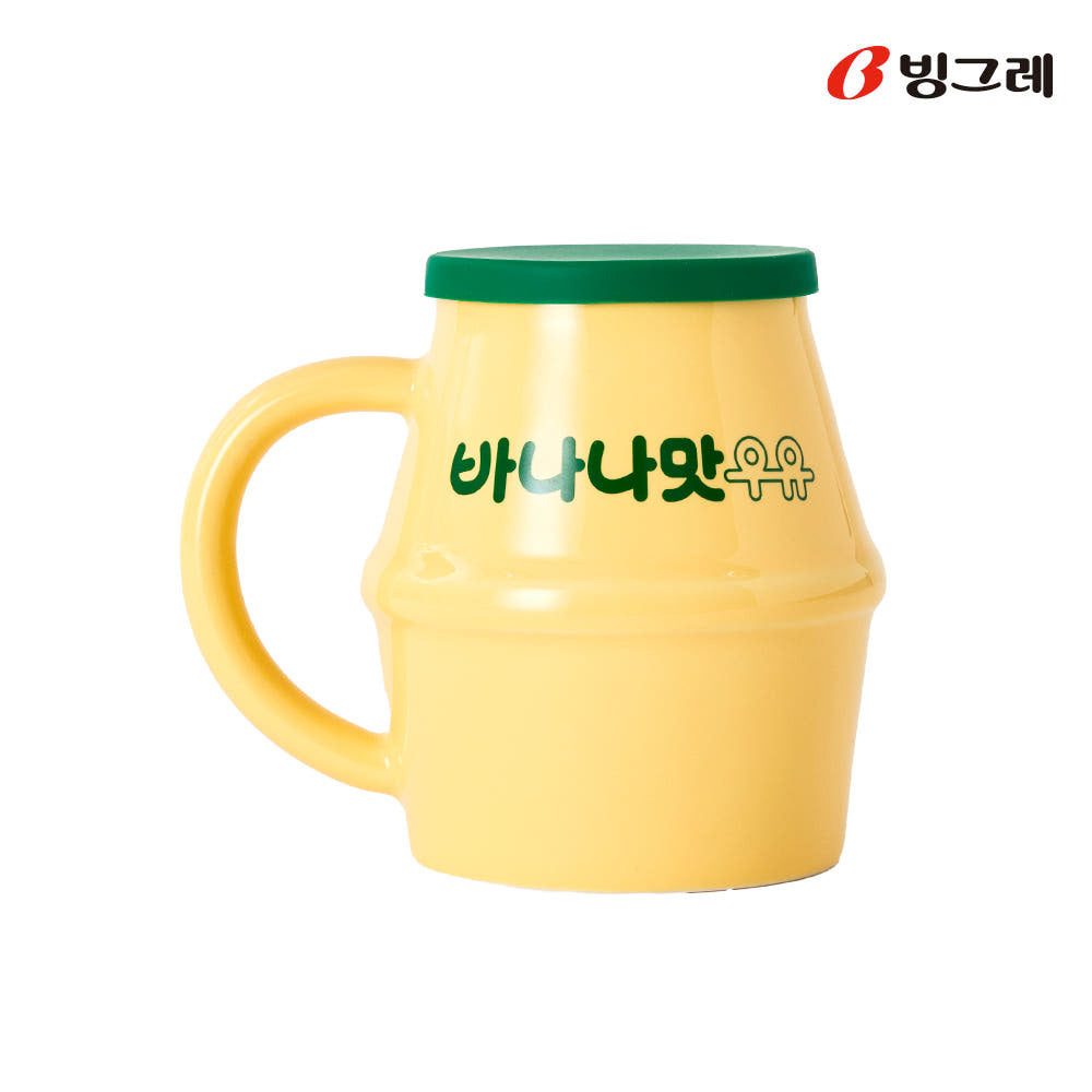 Binggrae banana milk ceramic mug with green silicone lid shown on a white background.