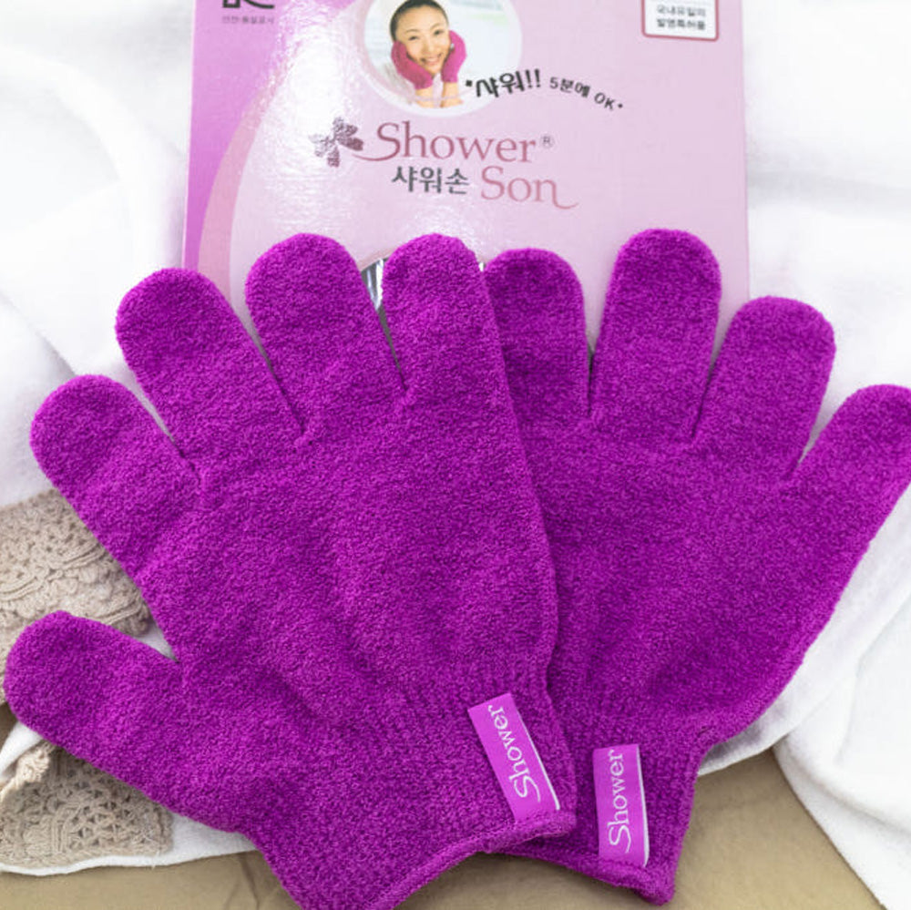 Pair of purple Korean exfoliating shower gloves with packaging