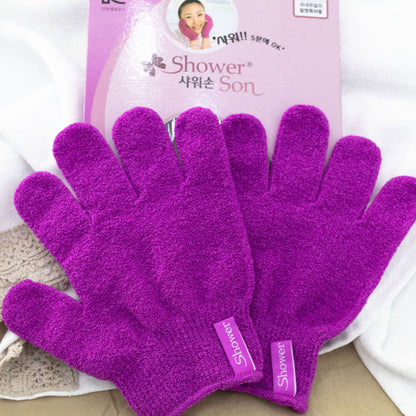 Pair of purple Korean exfoliating shower gloves with packaging