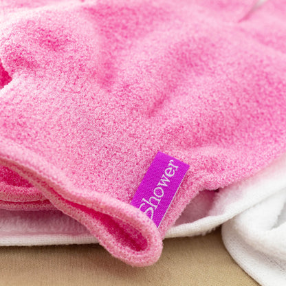 Close-up of pink Korean exfoliating shower glove