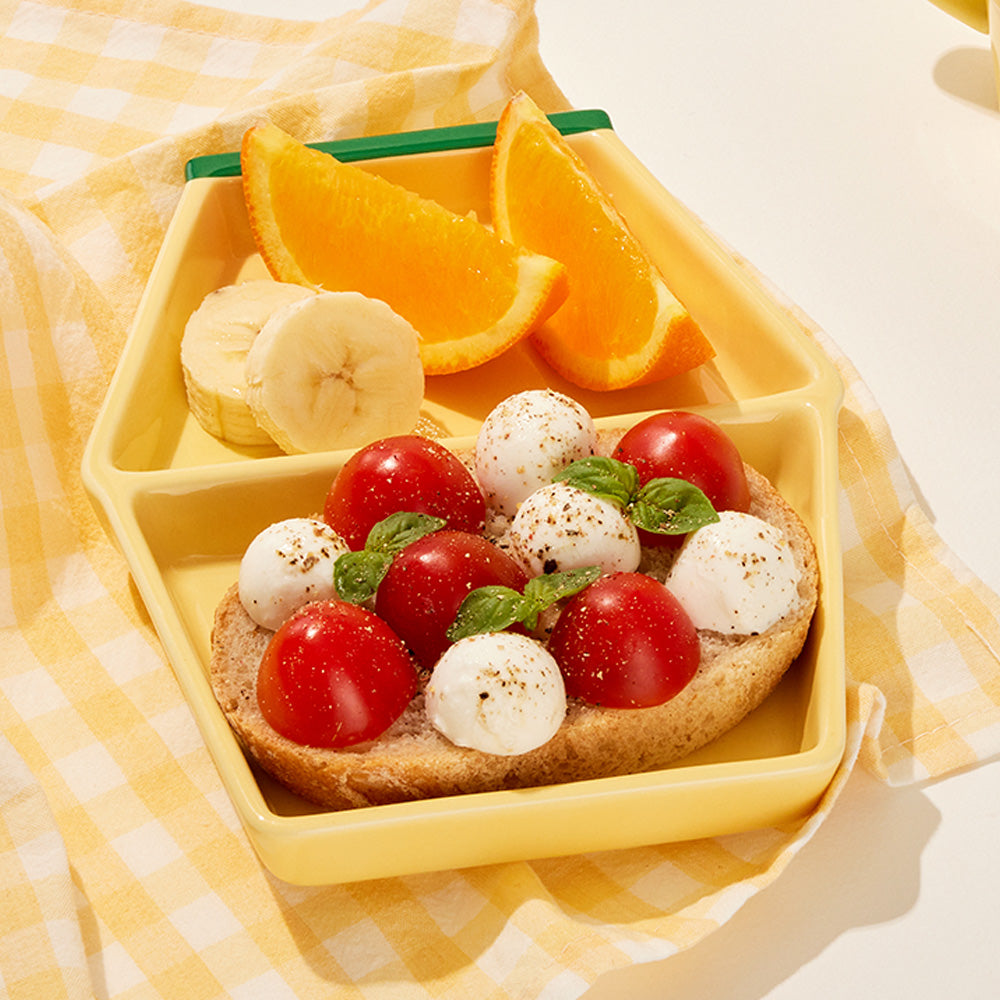 Binggrae Banana Milk divided plate serving oranges, bananas, and sandwich
