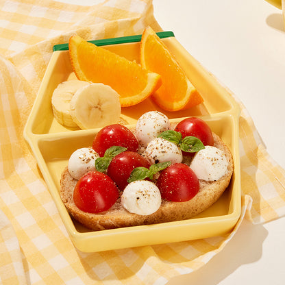Binggrae Banana Milk divided plate serving oranges, bananas, and sandwich
