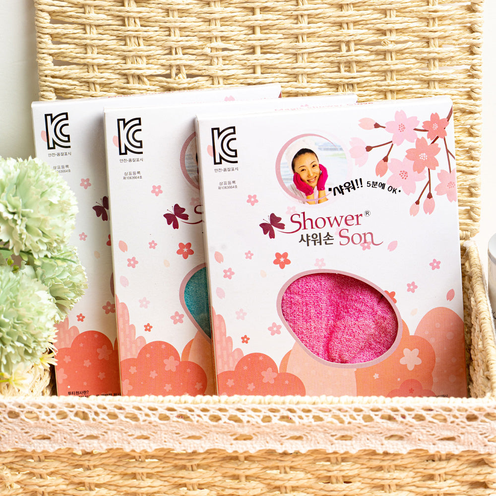 Korean exfoliating shower glove packages in basket with flowers